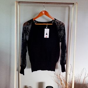 Zesica, size medium, black long sleeves with lace.